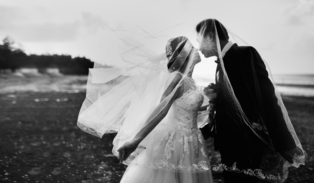 grayscale shot of bride and groom